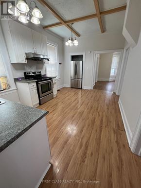 London East (East G) apartment for rent - A kitchen with wooden floors and white walls.