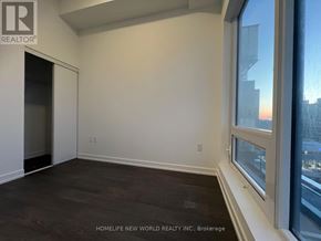 Toronto (Newtonbrook East) condo for rent - A room with a doorway leading to another room and a window with a view of the city.