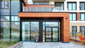 Richmond Hill condo for rent - The entrance to a building with a glass door and a sign that reads "REALTOR".