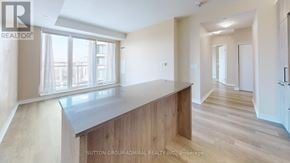 Richmond Hill condo for rent - A spacious room with a long counter and a window overlooking a cityscape.
