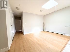 Hamilton apartment for rent - A room with wooden flooring and a skylight.