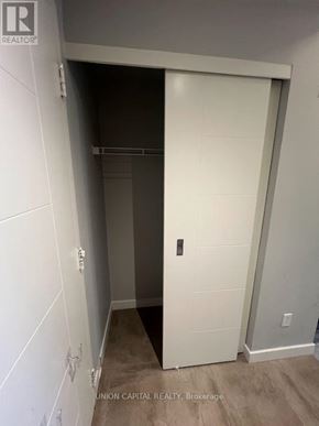 Waterloo condo for rent - A white door in a room with Union Capital Realty written on the bottom.