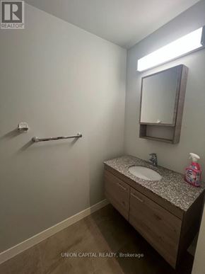 Waterloo condo for rent - A bathroom with a sink, mirror, and light.
