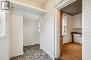 Hamilton (Landsdale) duplex for rent - A white room with a window and a door leading to another room.