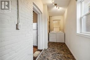 Hamilton (Landsdale) duplex for rent - A white brick wall with a doorway leading to another room.