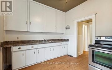 Hamilton (Landsdale) duplex for rent - A kitchen with white cabinets and a granite countertop.