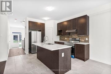 Ottawa apartment for rent - A kitchen with brown cabinets and a white counter.