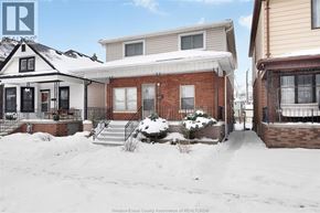 Windsor apartment for rent - A snowy scene with a house and a sign that says REALTOR.