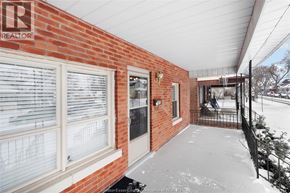 Windsor apartment for rent - A snowy porch with a brick wall and a sign that says REALTOR.