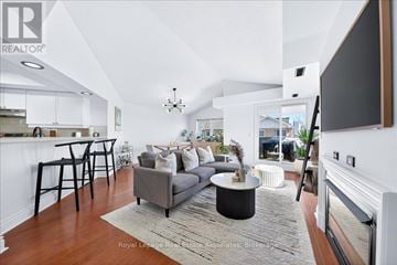 Mississauga (Hurontario) townhouse for rent - A living room with a grey couch and a black coffee table.