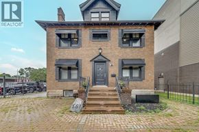 Windsor apartment for rent - A brick house with a black door and windows is for sale.