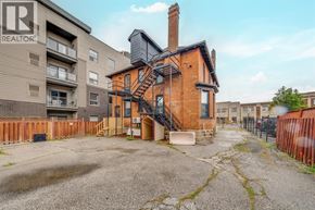 Windsor apartment for rent - A brick house with a black metal staircase in front of it.