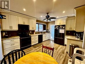 Niagara Falls (Ascot) apartment for rent - A kitchen with a table and chairs in the middle of it.