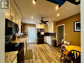 Niagara Falls (Ascot) apartment for rent - A kitchen with a ceiling fan and a dining table with chairs.