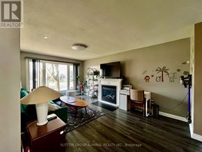 Niagara Falls (Ascot) apartment for rent - A living room with a fireplace and a television.