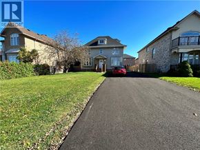 Stoney Creek apartment for rent - A residential street with houses on both sides and a car parked on the driveway.