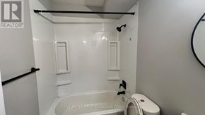 London East (East B) house for rent - A white bathroom with a tub and toilet.