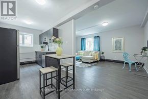 London East (East B) townhouse for rent - A well-lit kitchen and living room with a dining table and chairs.