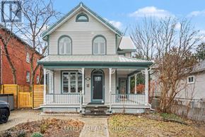 Ottawa apartment for rent - A house with a green roof and a porch with white railings.