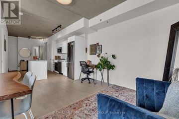 Ottawa condo for rent - A living room with a blue couch and a wooden table.