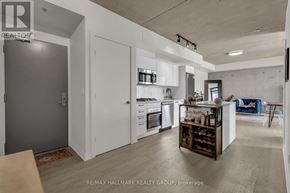 Ottawa condo for rent - A modern kitchen with white cabinets and a wooden island.