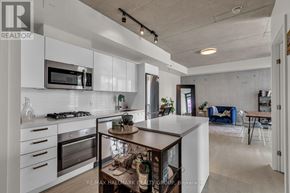 Ottawa condo for rent - A modern kitchen with white cabinets and a wooden island.
