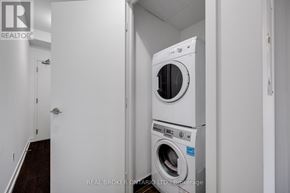 Toronto (Niagara) condo for rent - A white washer and dryer in a small laundry room.