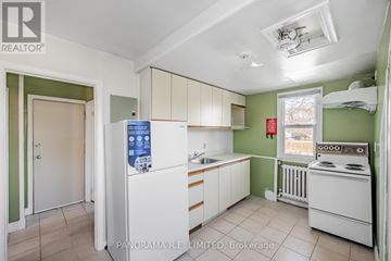 Toronto (Long Branch) apartment for rent - A kitchen with white appliances and green walls.