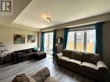 Hamilton (Stoney Creek) townhouse for rent - A living room with two couches and a fishbowl on the table.