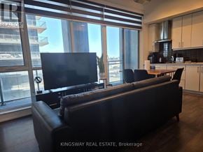 Toronto (Banbury-Don Mills) condo for rent - A living room with a couch and a television.