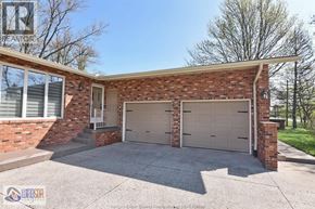 Windsor apartment for rent - A two-car garage is attached to a brick house.