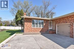 Windsor apartment for rent - A house with a brick facade and a white garage door.
