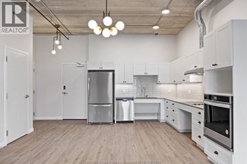 Windsor apartment for rent - A kitchen with white cabinets and a wooden floor.