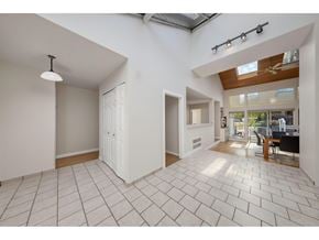 Surrey apartment for rent - A spacious room with a tiled floor and a skylight.