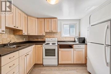 Ottawa condo for rent - A kitchen with wooden cabinets and a white refrigerator.