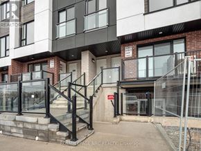 St. Catharines (E. Chester) townhouse for rent - A building with a glass railing and a sign that says "STOP".