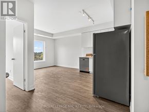 St. Catharines (E. Chester) townhouse for rent - A spacious room with a blackboard and a fridge.