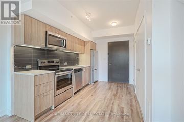 Toronto (L'amoreaux) townhouse for rent - A modern kitchen with wooden cabinets and stainless steel appliances.
