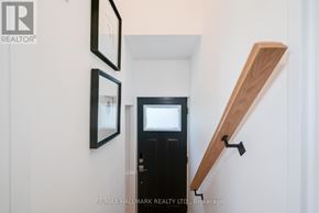 Toronto (Birchcliffe-Cliffside) apartment for rent - A black door is flanked by two mirrors on a white wall.