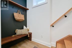 Toronto (Birchcliffe-Cliffside) apartment for rent - A staircase with a wooden banister and a wicker basket hanging on the wall.