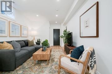 Toronto (Birchcliffe-Cliffside) apartment for rent - A living room with a grey couch, a wooden coffee table, and a large painting on the wall.