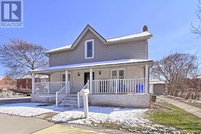 Oshawa (Central) triplex for rent - A house with a grey roof and a white fence.