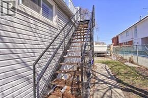 Oshawa (Central) triplex for rent - A staircase with a metal railing leads up to a building.