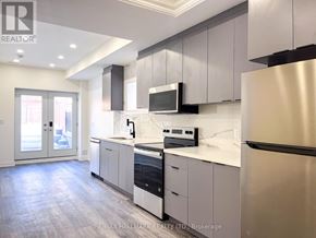 Richmond Hill (Mill Pond) apartment for rent - A modern kitchen with stainless steel appliances and white cabinetry.