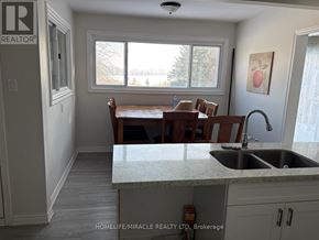 New Tecumseth apartment for rent - A kitchen with a sink, counter, and a window.