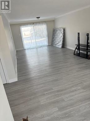 New Tecumseth apartment for rent - A room with wooden flooring and a window with blinds.