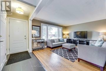 Toronto (Alderwood) apartment for rent - A living room with a grey couch and a black and white rug.