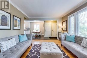 Toronto (Alderwood) apartment for rent - A living room with a grey couch and a rug in the middle.