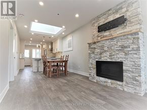 Toronto (Briar Hill-Belgravia) apartment for rent - A stone fireplace is built into a wall in a spacious room.