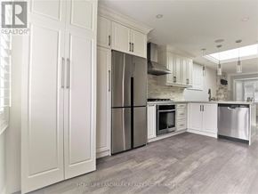 Toronto (Briar Hill-Belgravia) apartment for rent - A kitchen with white cabinets and stainless steel appliances.